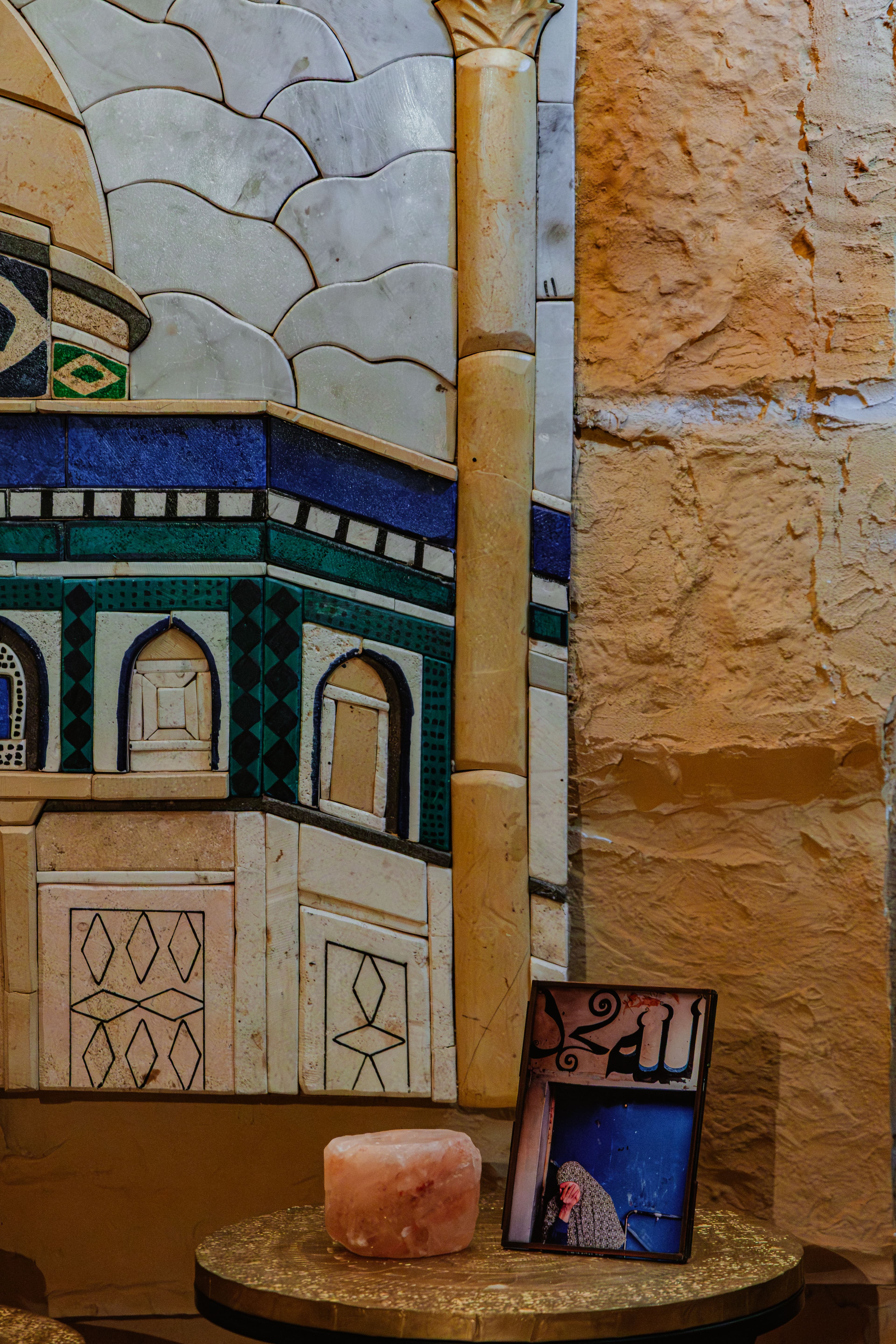 A stone mosaic of the Dome of the Rock on the House wall.